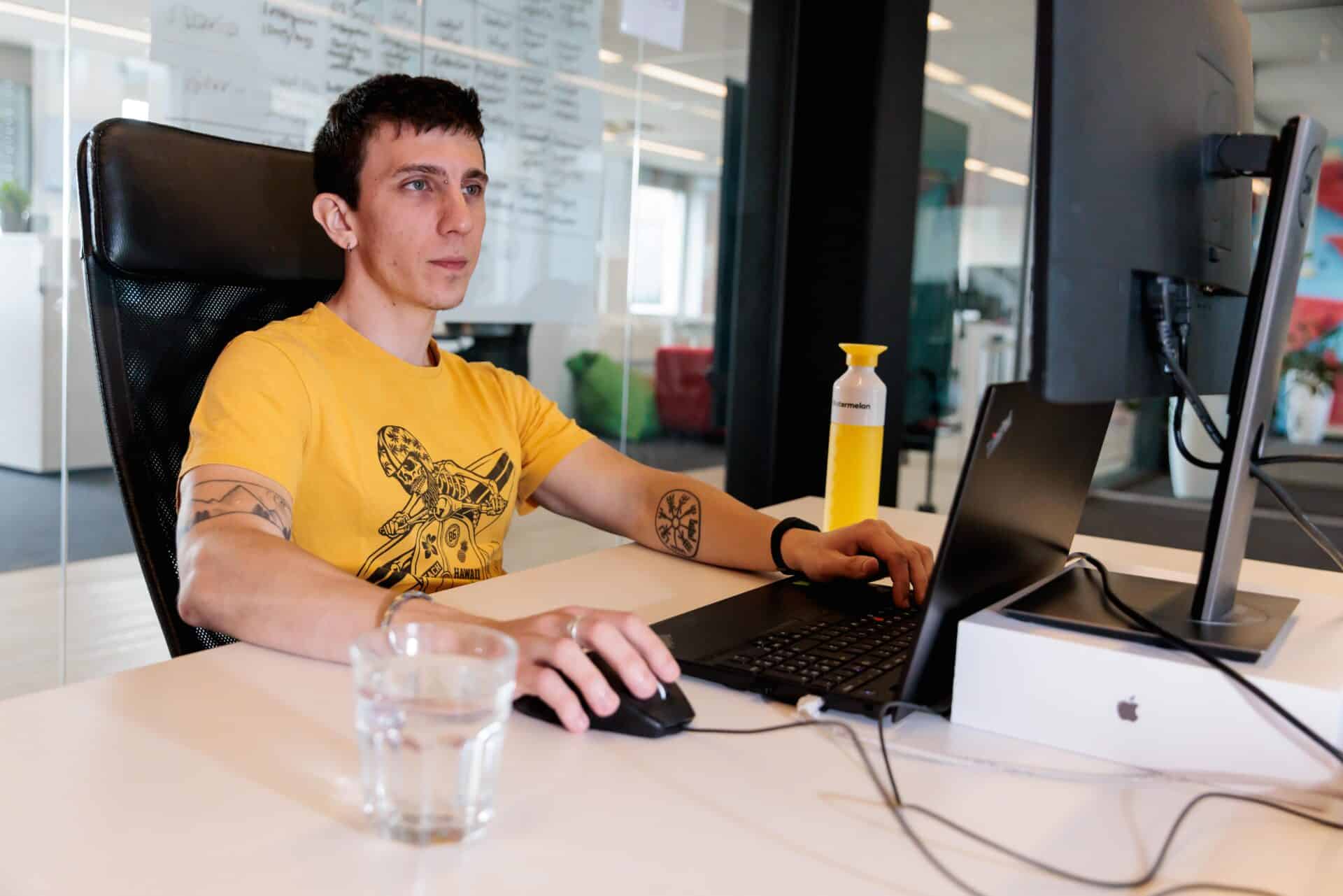 Watermelon team member behind the computer Watermelon team member behind the computer